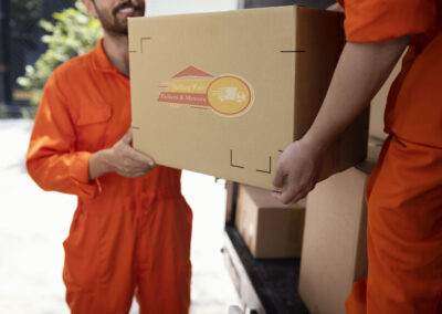 close up young delivery men moving objects out car